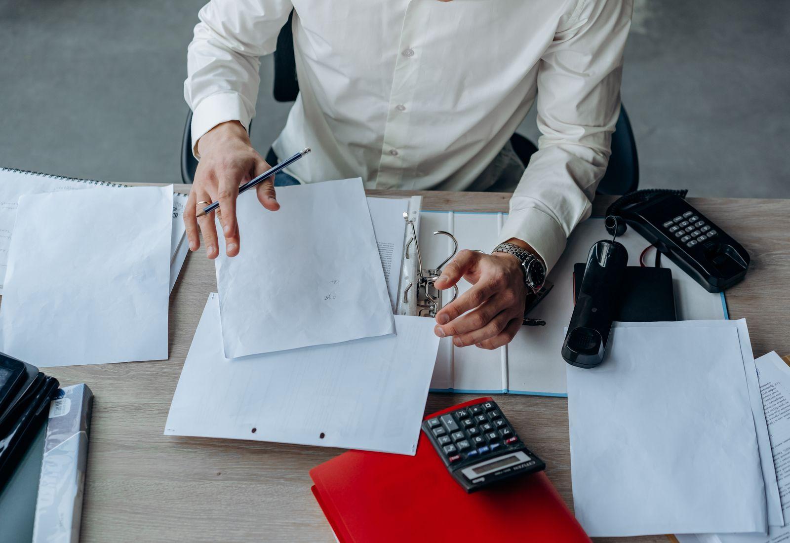 Business documents and paperwork laid out on an office desk (customs documentation).